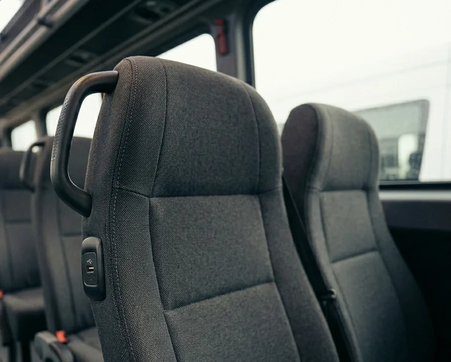Mini Bus comfort detail — seats, USB ports and amenities